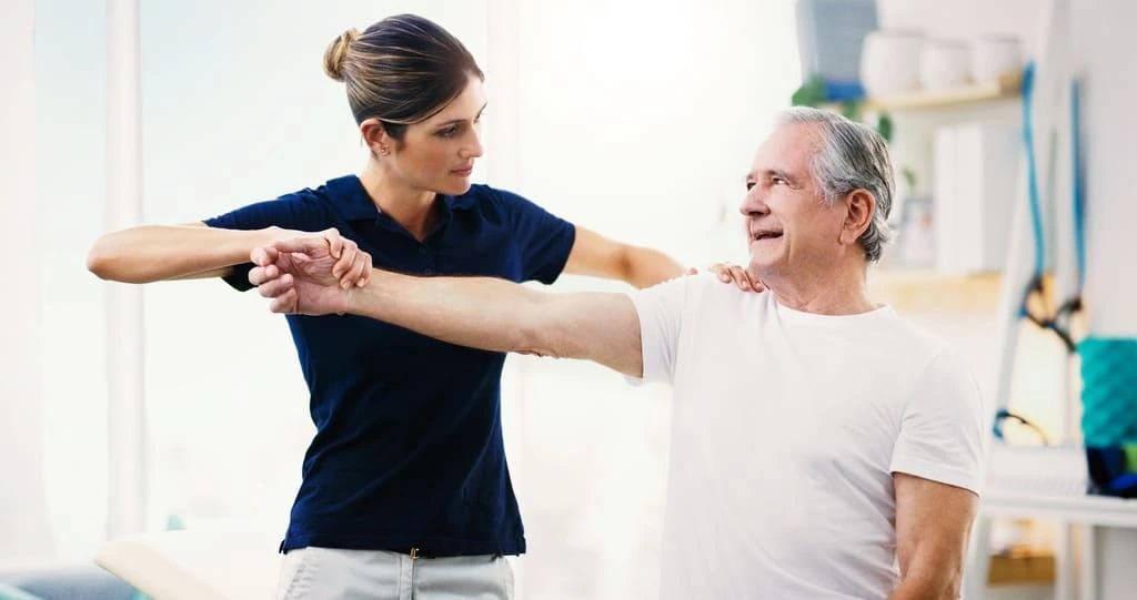 live-in carer helping a senior to stretch