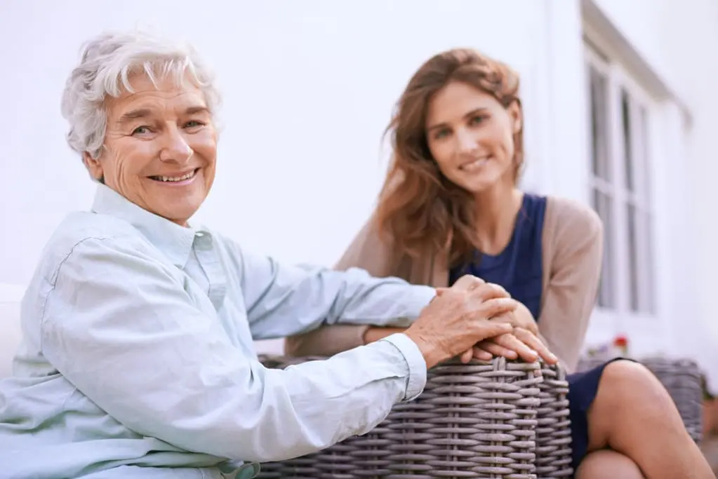 support worker sitting with an elderly woman