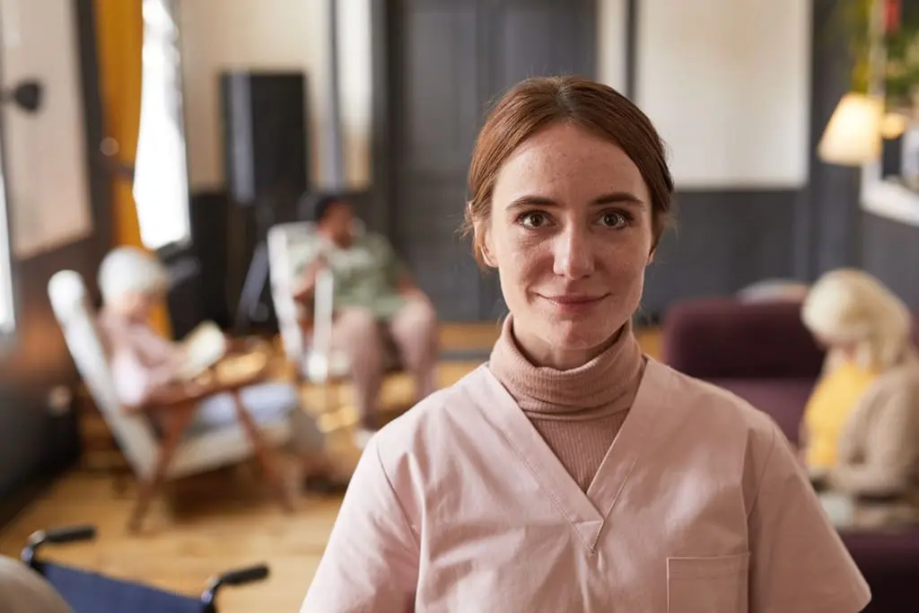 community psychiatric nurse with elderly people in background